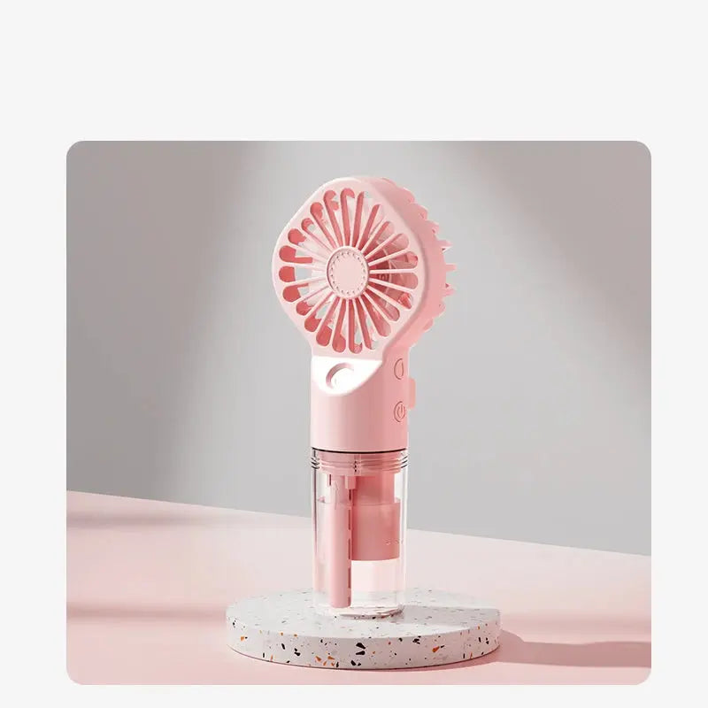 Mini fan with charging cable and spray. True Value