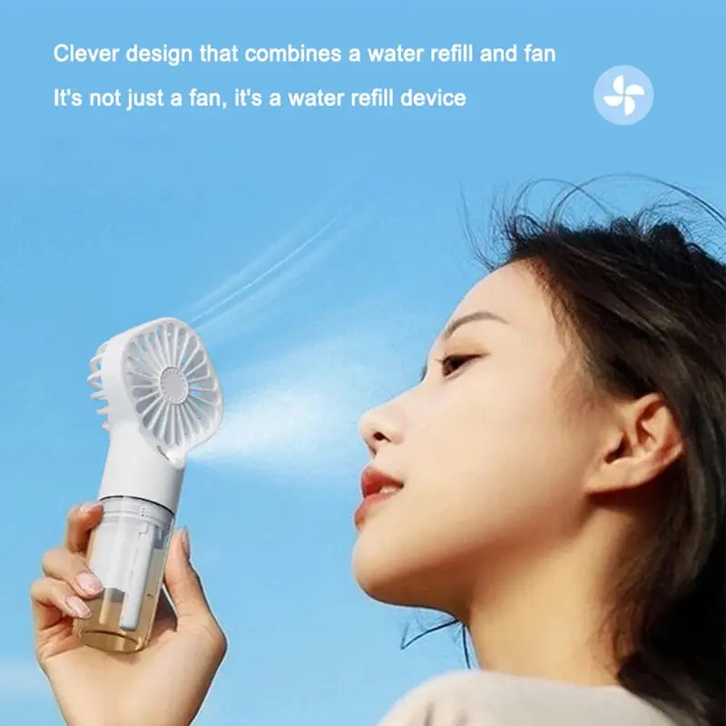 Mini fan with charging cable and spray. True Value