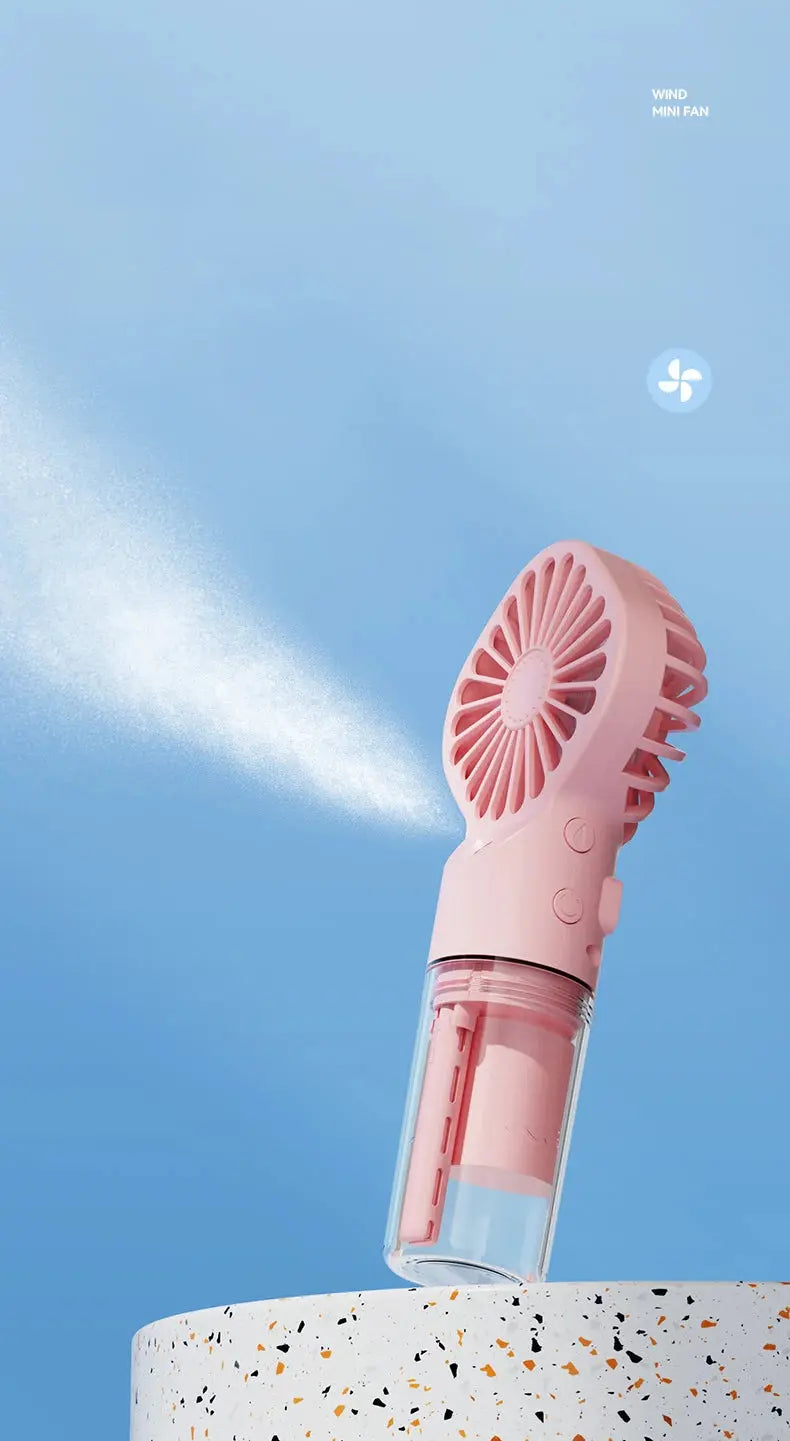 Mini fan with charging cable and spray. True Value